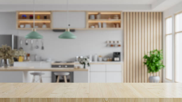 istock Wooden table top on blur kitchen room background,Modern kitchen room interior. 1405246066