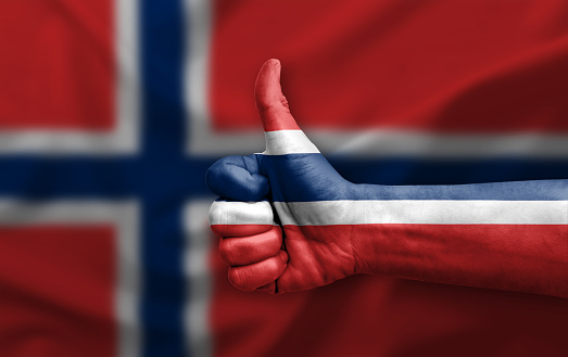 Hand making thumb up painted with flag of norway