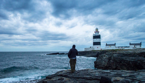 Hook lighthouse at Wexford Ireland in a cloudy night stock photo