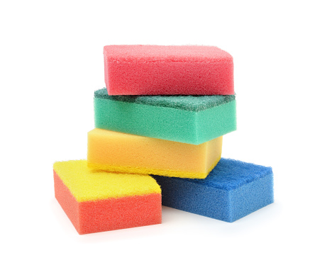 Stack of multi-colored dish sponges isolated on white.
