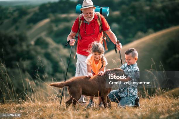 Picture Of Family Going For A Picnic Climbing A Hill Stock Photo - Download Image Now
