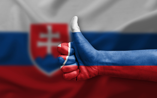 Hand making thumb up painted with flag of slovakia