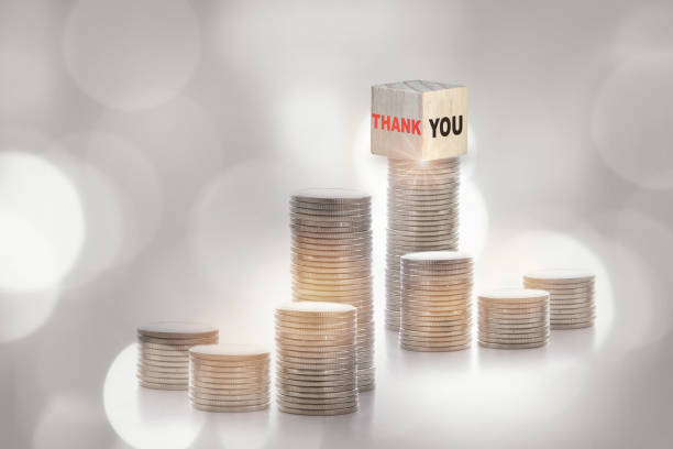 istock Thank you on cube on stack of coins on abstract background 1405248369