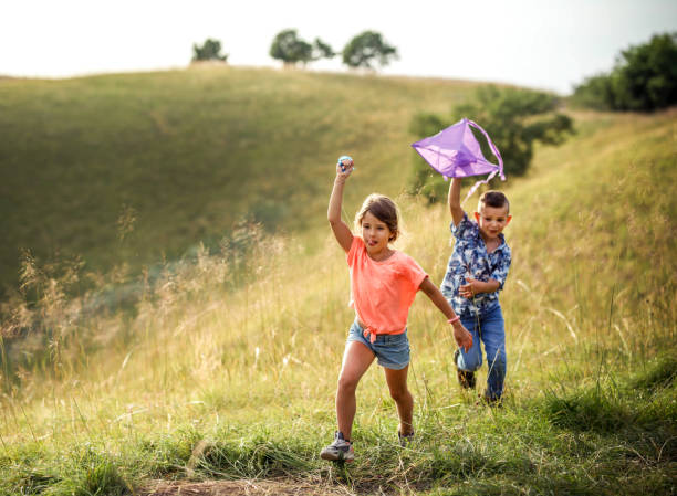 istock brother and sister play in nature 1405249905
