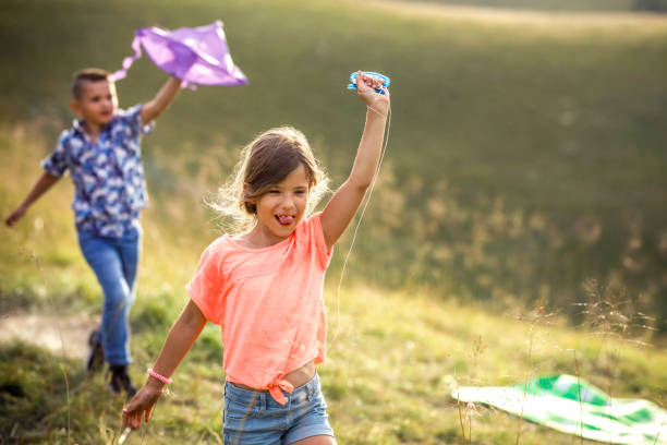 istock brother and sister play in nature 1405249922