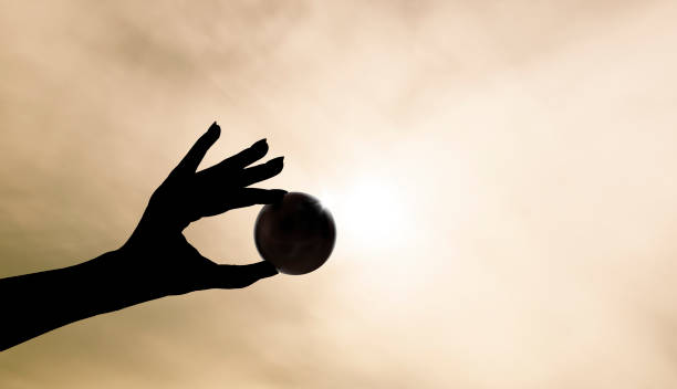 istock Female hand holding a black ball 1405252730