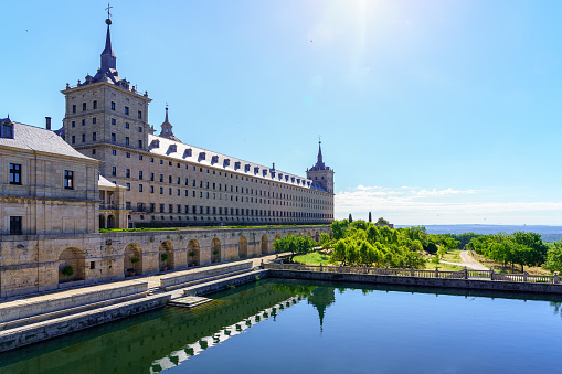 Side facade of the Escorial monastery and water reservoir with gardens, copyspace