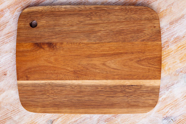 istock Natural brown wood cutting board on wooden table 1405253106