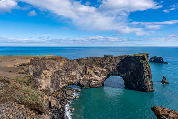 istock Gorgeous landscape with unique basalt arch on Dyrholaey Endless Beach Nature Reserve on Atlantic South Coast. 1405255614