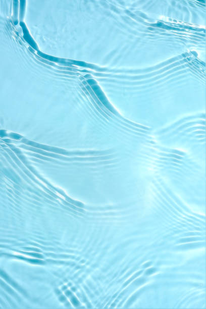 A macro close-up of a glossy liquid mercury surface capturing gentle ripples that create a shimmering, silver effect, indistinguishable from a tranquil lake. Differential focus emphasises the realistic water-like texture, with ample copy space on the right. Ideal for themes of nature, serenity, abstract design, and reflective surfaces.