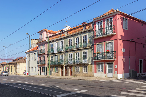 Old beautiful houses with balconies on Rua da Junqueira or Junqueira street. Lisbon, Portugal