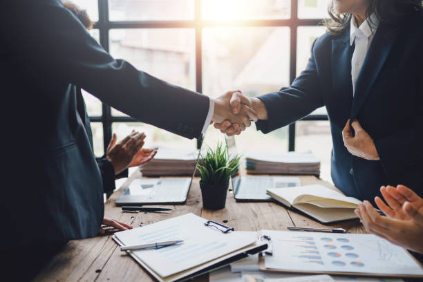 empresarios dándose la mano para felicitar el éxito. los ejecutivos de negocios se apretujan de manos para felicitar el acuerdo comercial conjunto. - takeover fotografías e imágenes de stock