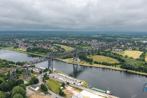 Rendsburg, Schleswig-Holstein, Germany - June 2022: Train on the Rendsburg High Bridge (Rendsburger Hochbrücke) - railway viaduct of Neumünster–Flensburg line
