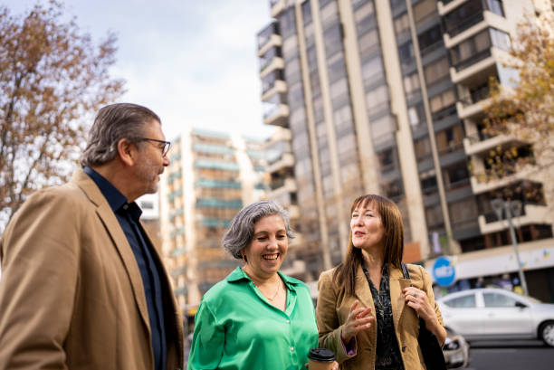 istock Coworkers walking and talking outdoors 1405260723