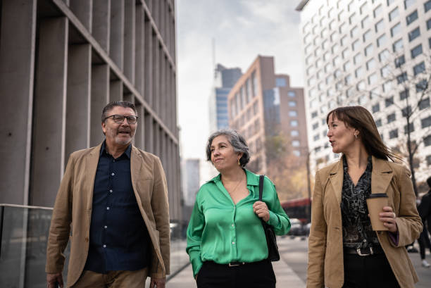 istock Coworkers walking and talking outdoors 1405261459