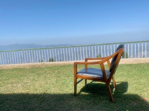 Wooden chair placed in grassy lawn