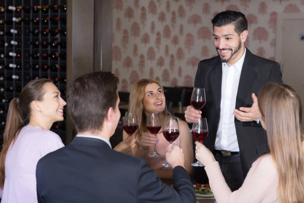 istock Glad man pronouncing toast in cozy restaurant 1405264485