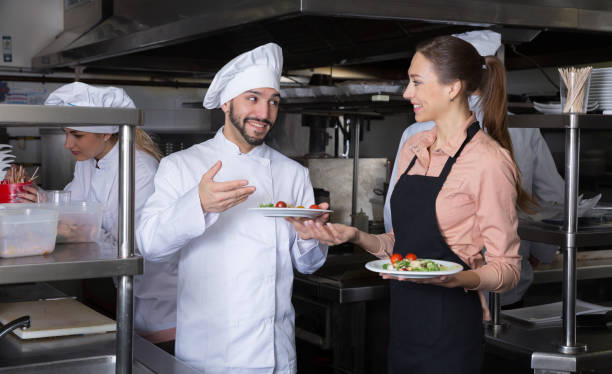 istock Chef with team preparing food 1405264489