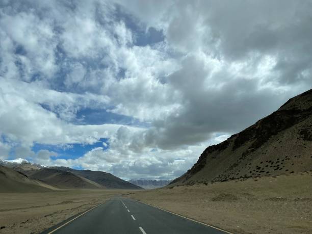 istock Empty road view with mountain in the background 1405265064