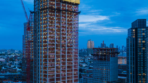 istock Modern apartment tower construction at night - construction site in the city 1405265071