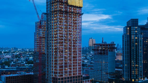 istock Modern framed apartment condo tower construction - construction site in the night 1405265079