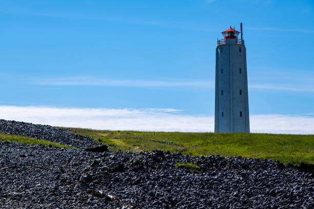 Malariff Lighthouse Lava formations meet the ocean at Londragar, Iceland.