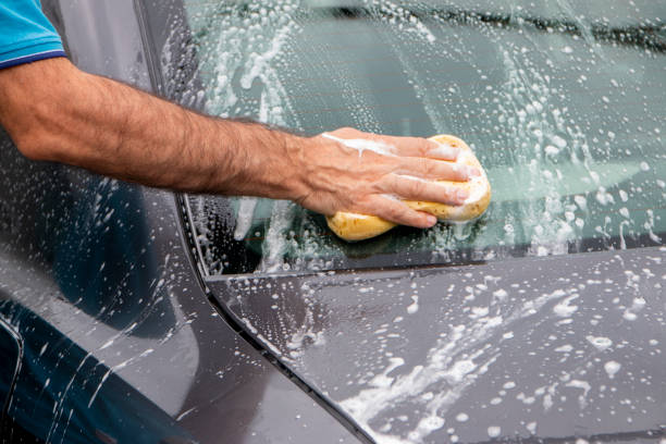 istock Car wash concept. Mature man cleaning automobile with foam. 1405265521
