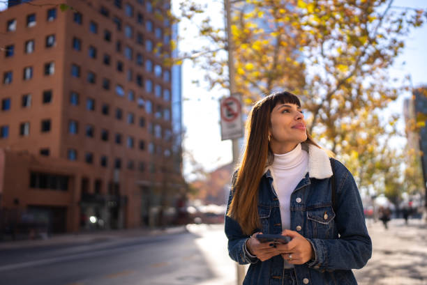 Young woman using mobile phone in the city
