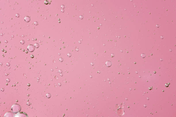 istock oil with bubbles on light pink coral monochrome background 1405265693