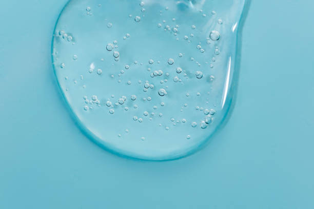 istock Close up macro Aloe vera gel cosmetic texture blue background with bubbles. 1405265914