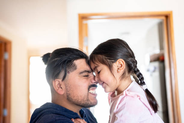 istock Father holding daughter at home 1405266005