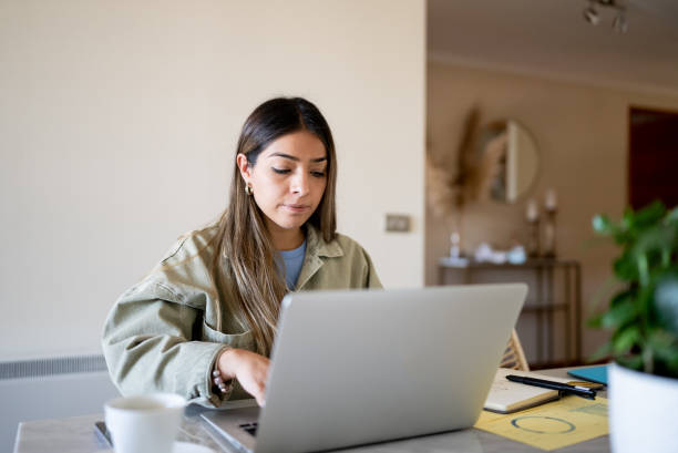 istock Woman using laptop working at home 1405266650