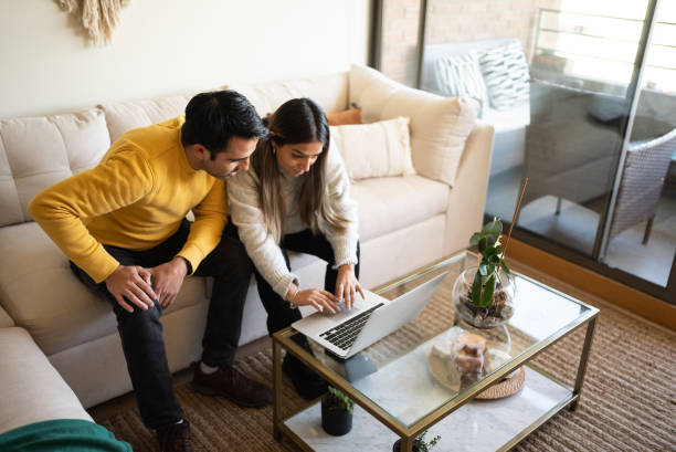 istock Couple using laptop at home 1405266725