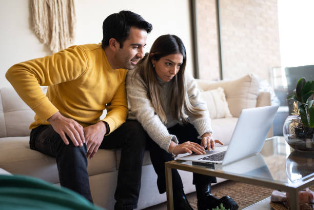 istock Couple using laptop at home 1405266740