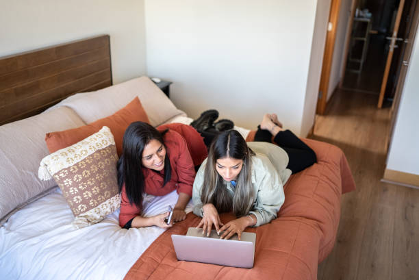 istock Women in bed using laptop together 1405266742