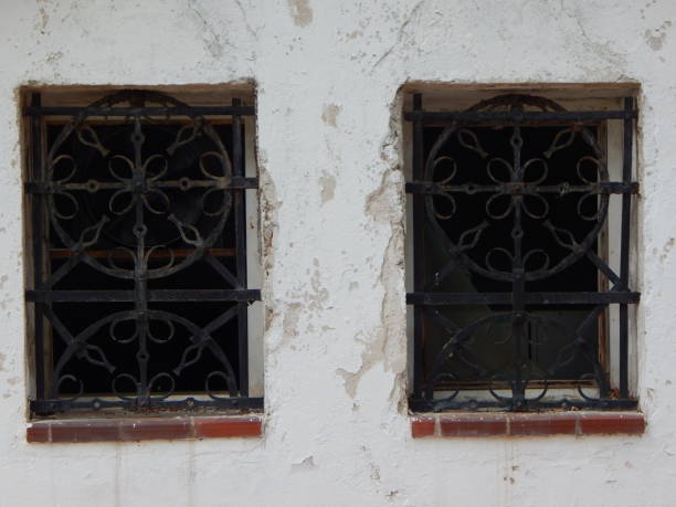 istock Wrought iron window protection on old house windows 1405266835