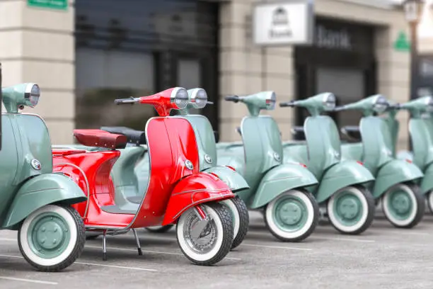 Photo of Vintage moped scooter in row on a parking of the city.