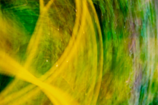 Radiation abstraction. Acid yellow green background with waves, dots, distortions. Backdrop