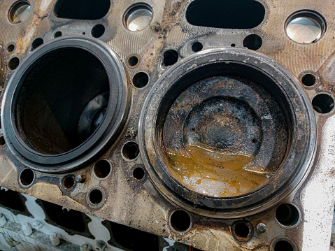 A grayscale shot of gear mechanisms of a locomotive engine, emphasizing the intricate details of its machinery