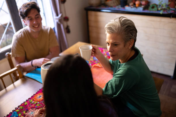 istock Family talking while drinking coffee at home 1405267238