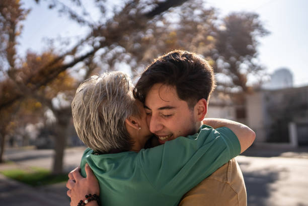 istock Mother and son embracing outdoors 1405267393