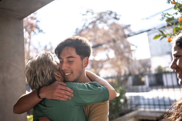 istock Mother welcoming son at home 1405267481