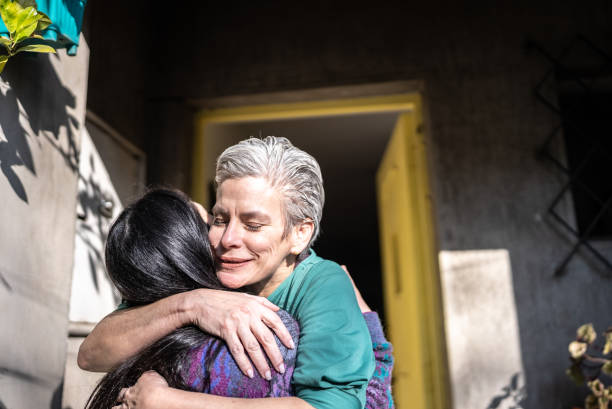 Mother welcoming daughter at home