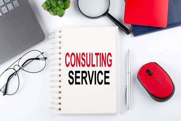istock CONSULTING SERVICE text on a notepad with laptop on the white background 1405268236