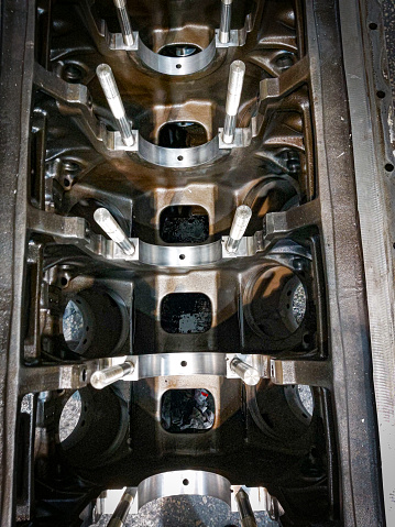 Engine parts, Machine Valve, Engine Block, Cylinder, Chrome material, Machine Parts. Valve in a deposit on the removed cover of the engine valve box.