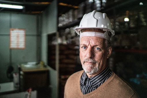 Portrait of a warehouse worker using a helmet
