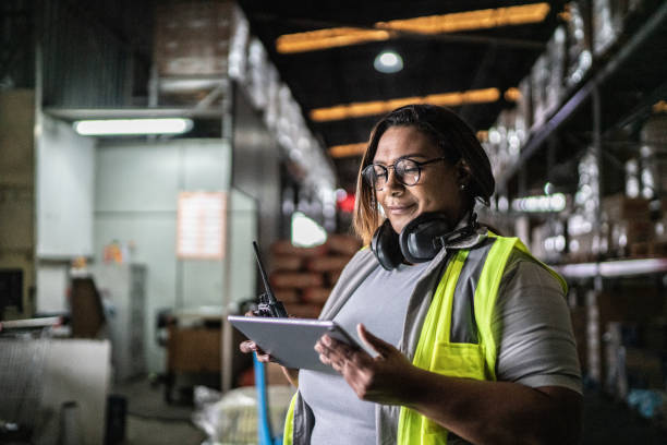 istock Mature woman using digital tablet in a warehouse 1405272620