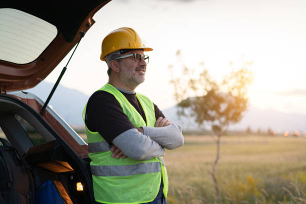 istock portrait of engineer leaning on his car at sunset 1405273603