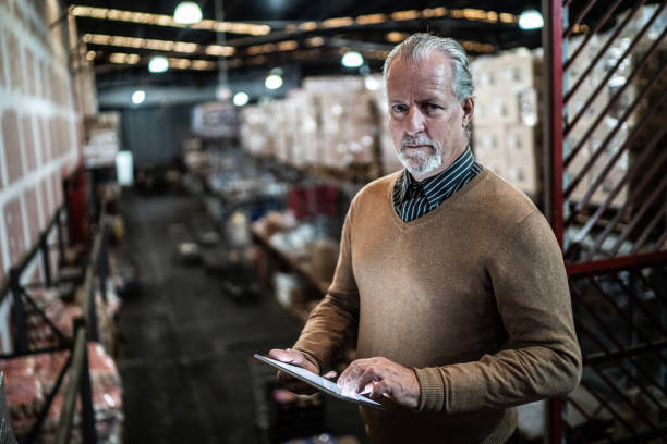 istock Portrait of a warehouse worker using digital tablet 1405273635