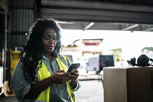 Warehouse worker using smartphone